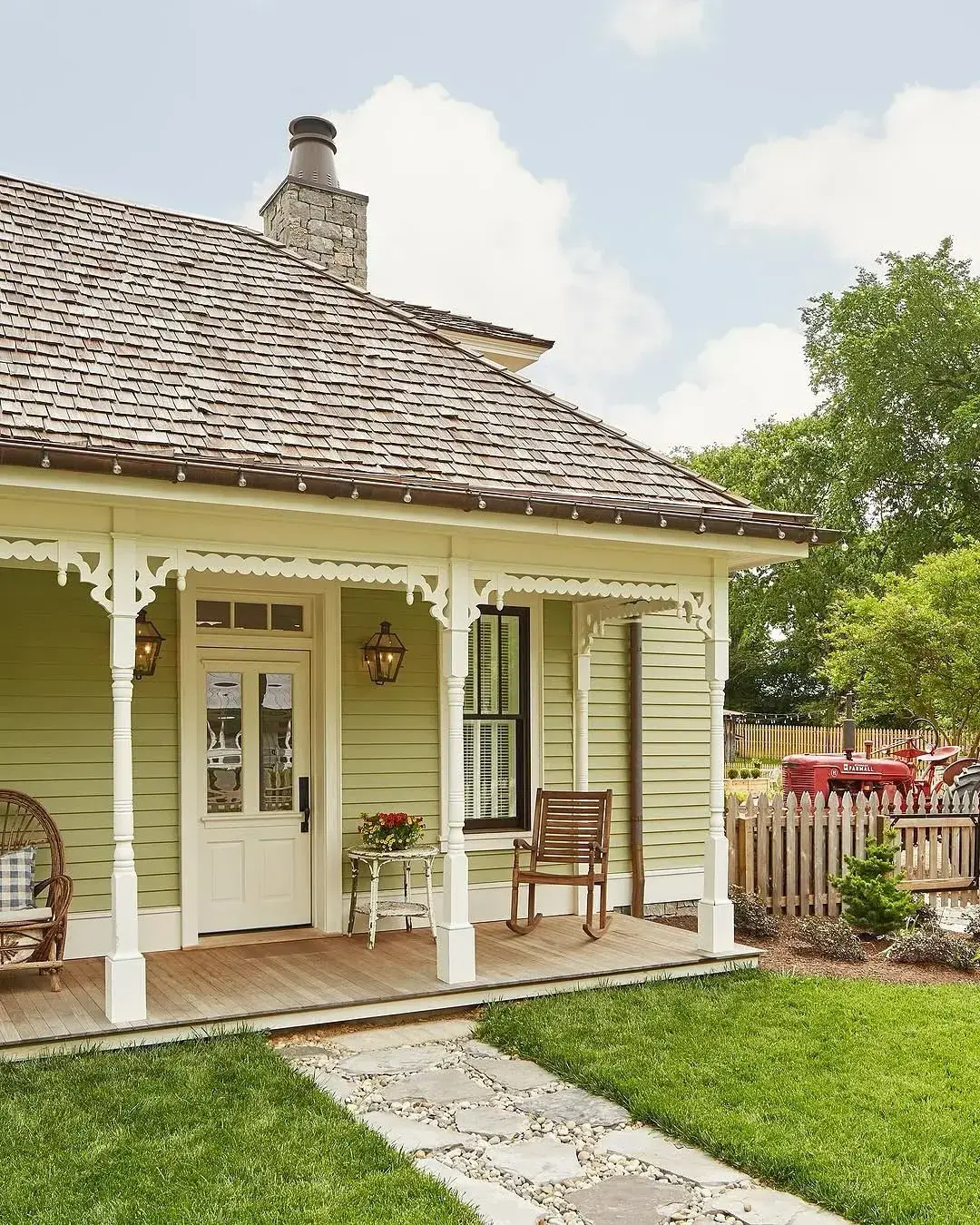 Sage green cottage front porch with a green door