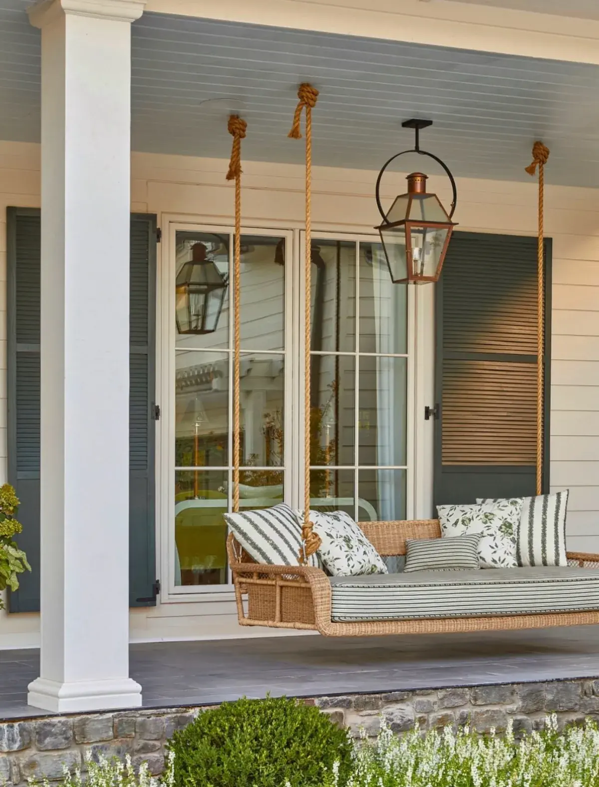 Front porch rope hanging swing bed swaying under the beams