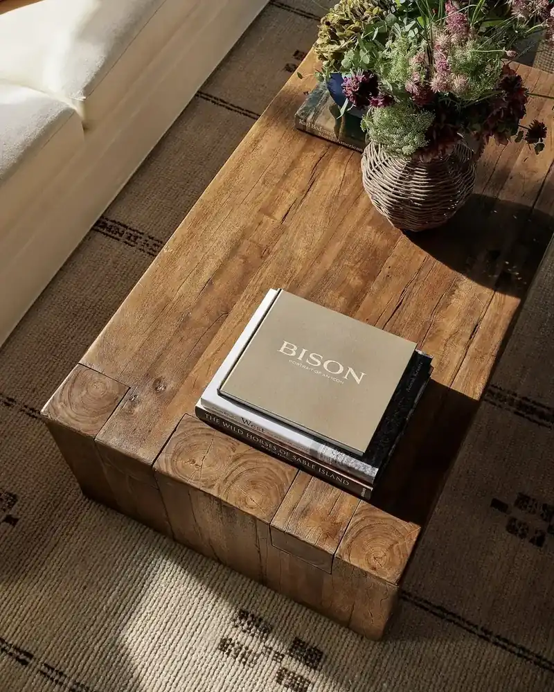 Reclaimed pine coffee table built from end-grain blocks with a stack of books and dried flowers