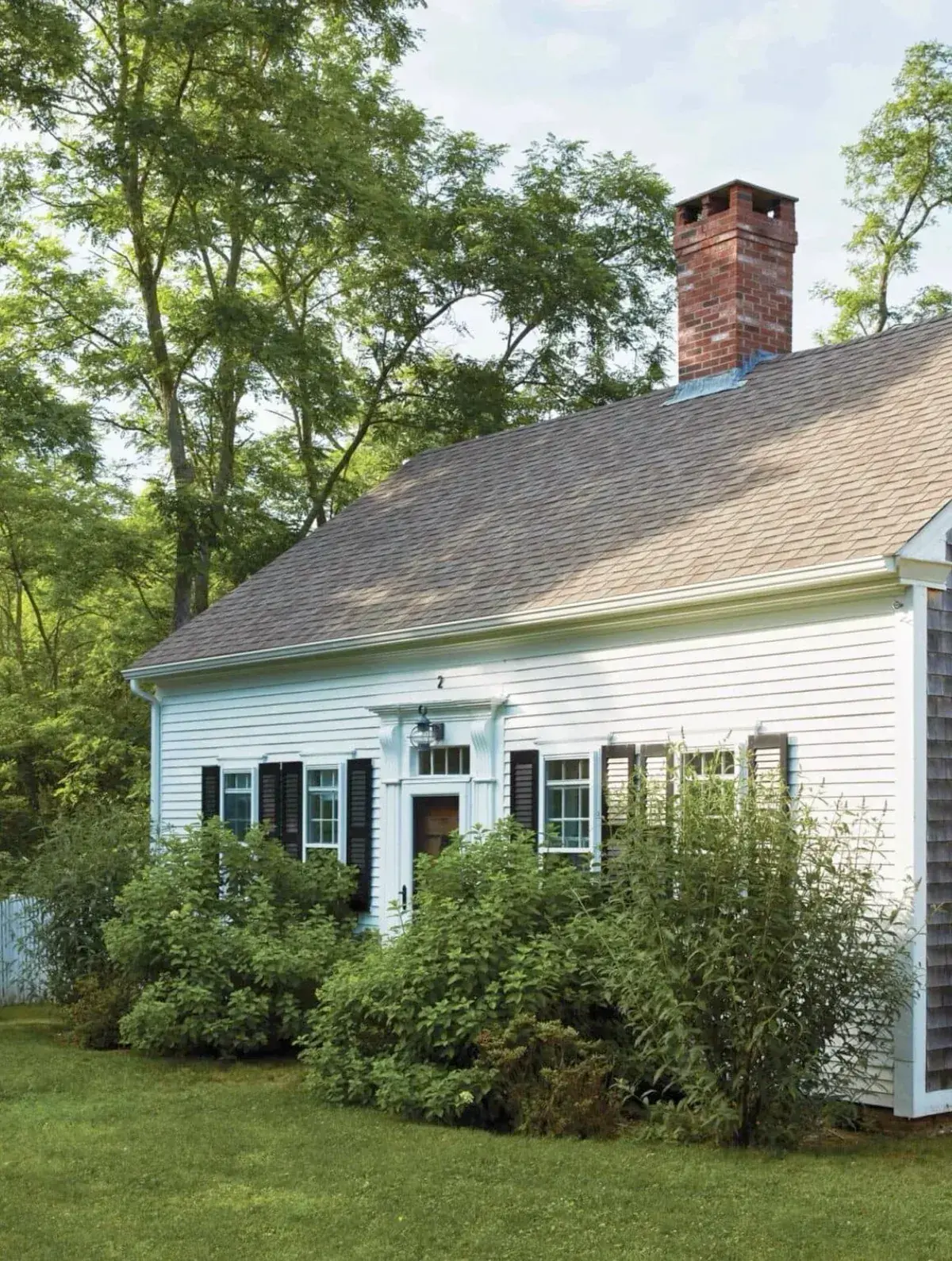 White Cape Cod house with black shutters