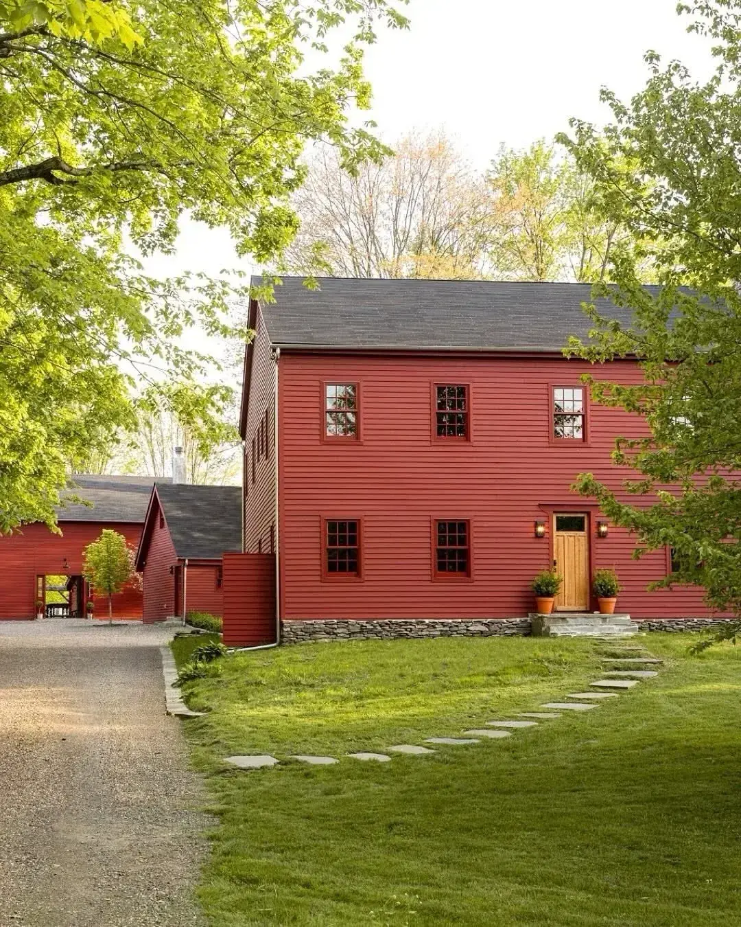 Rustic red barn style home with white trim