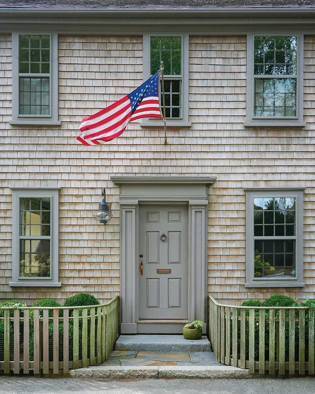 Coastal cottage with a grey front door and pale walls
