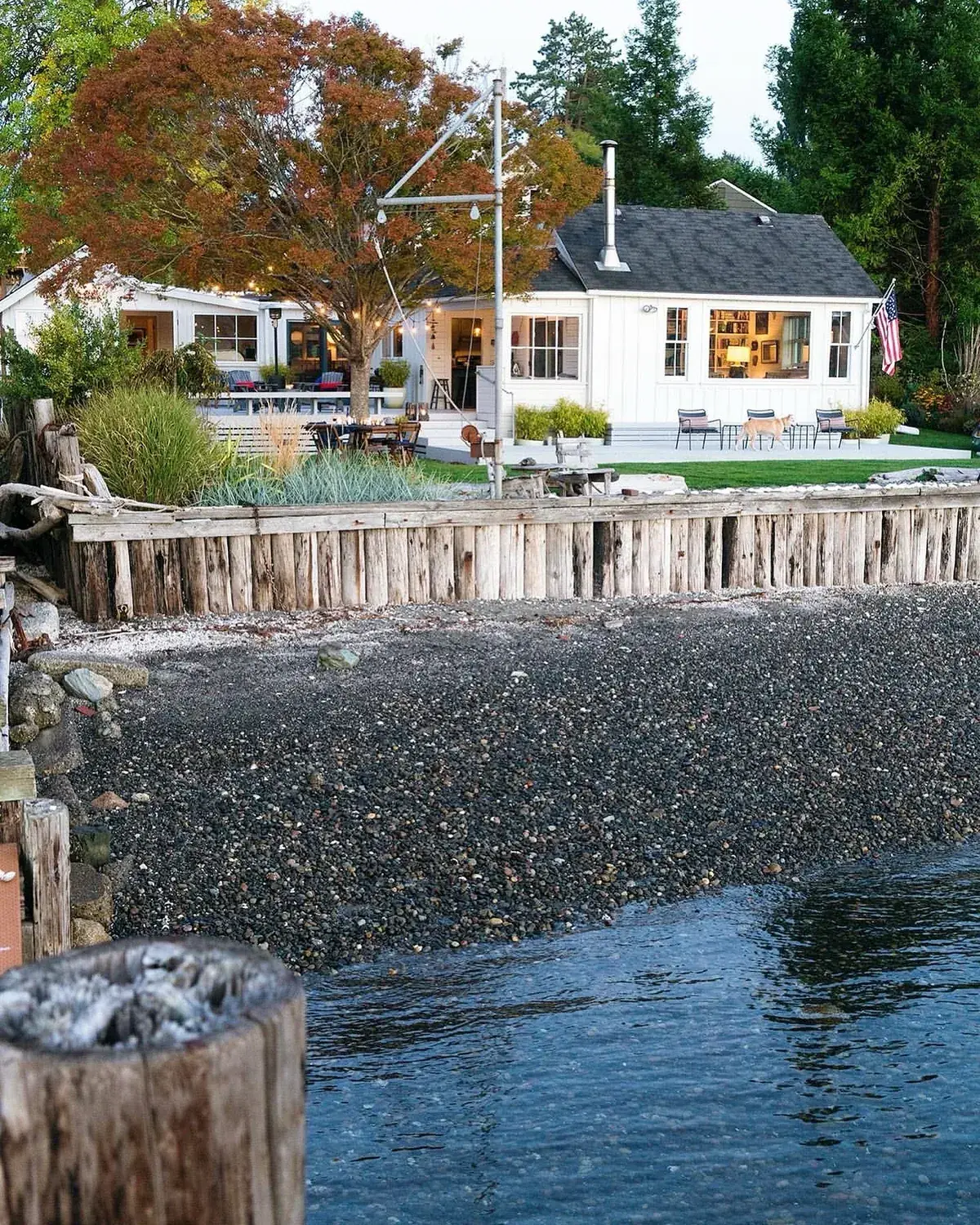 Cosy waterfront cottage home exterior with a porch facing the view