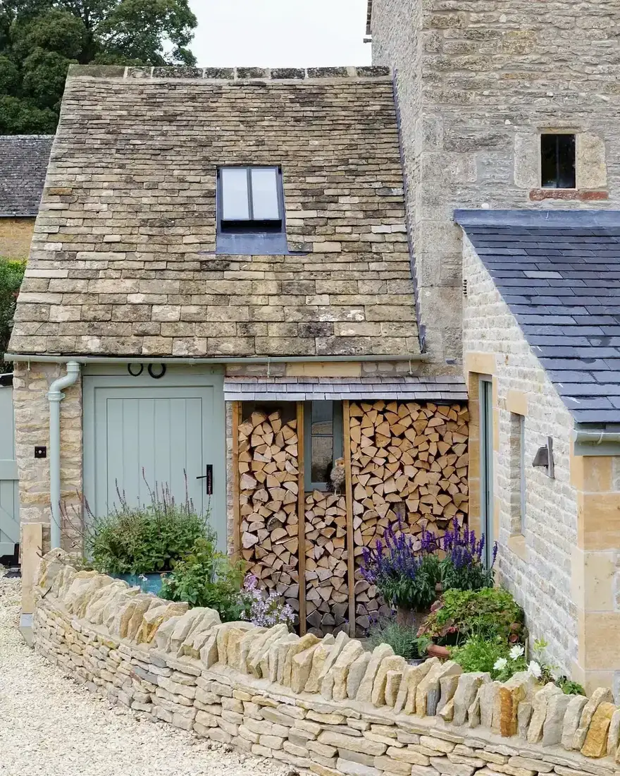 Cotswold stone cottage with log store and blue door