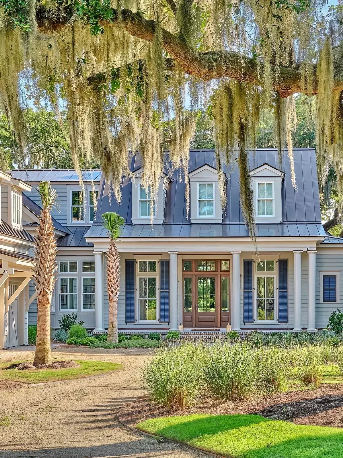 Blue coastal stucco house with palms and Spanish moss