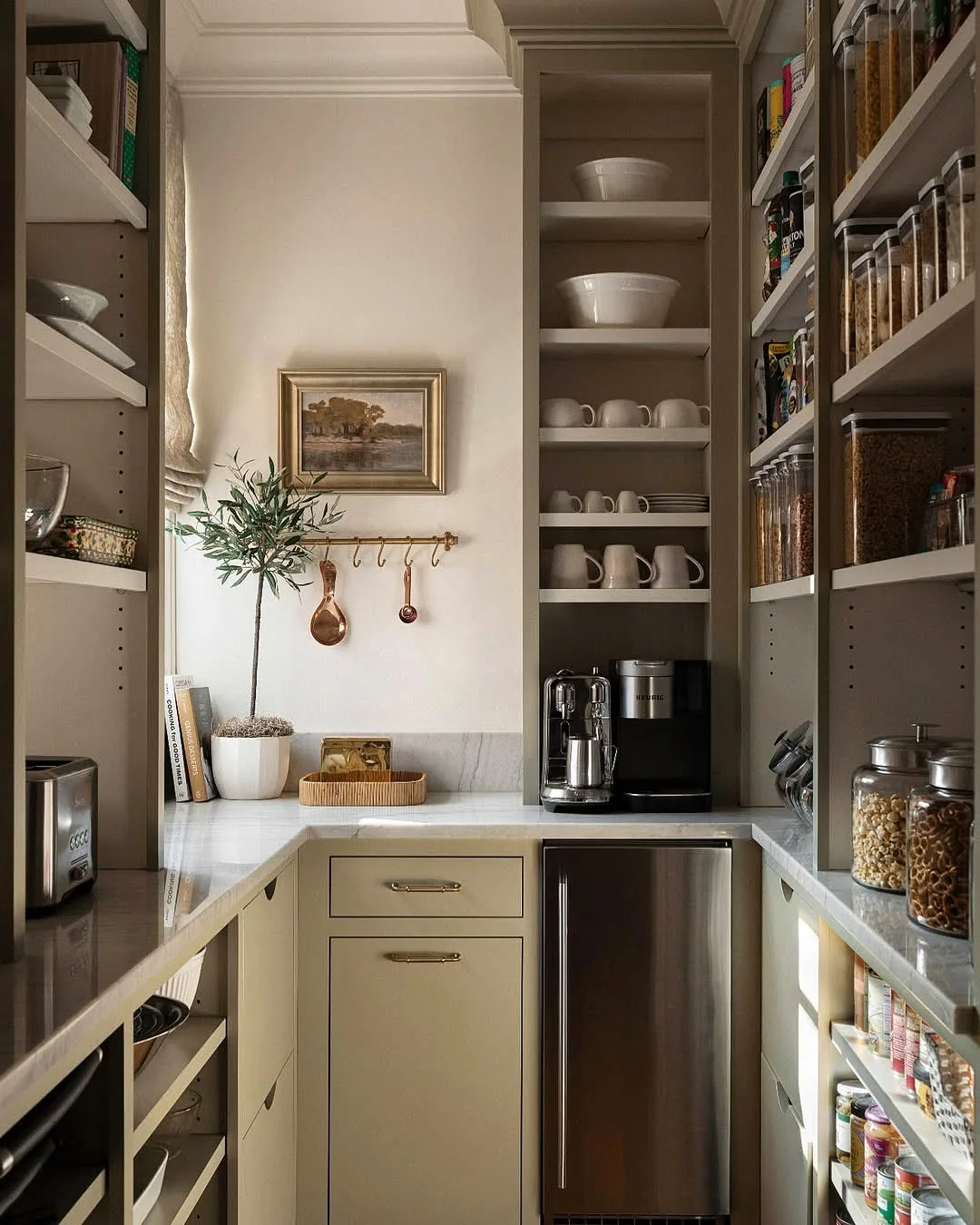 L shaped pantry with coffee station, fridge drawer, open shelves and bowls