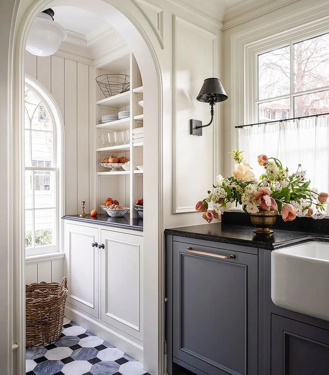 Marble hexagon and cabochon floor confined to a pantry beyond an arched opening