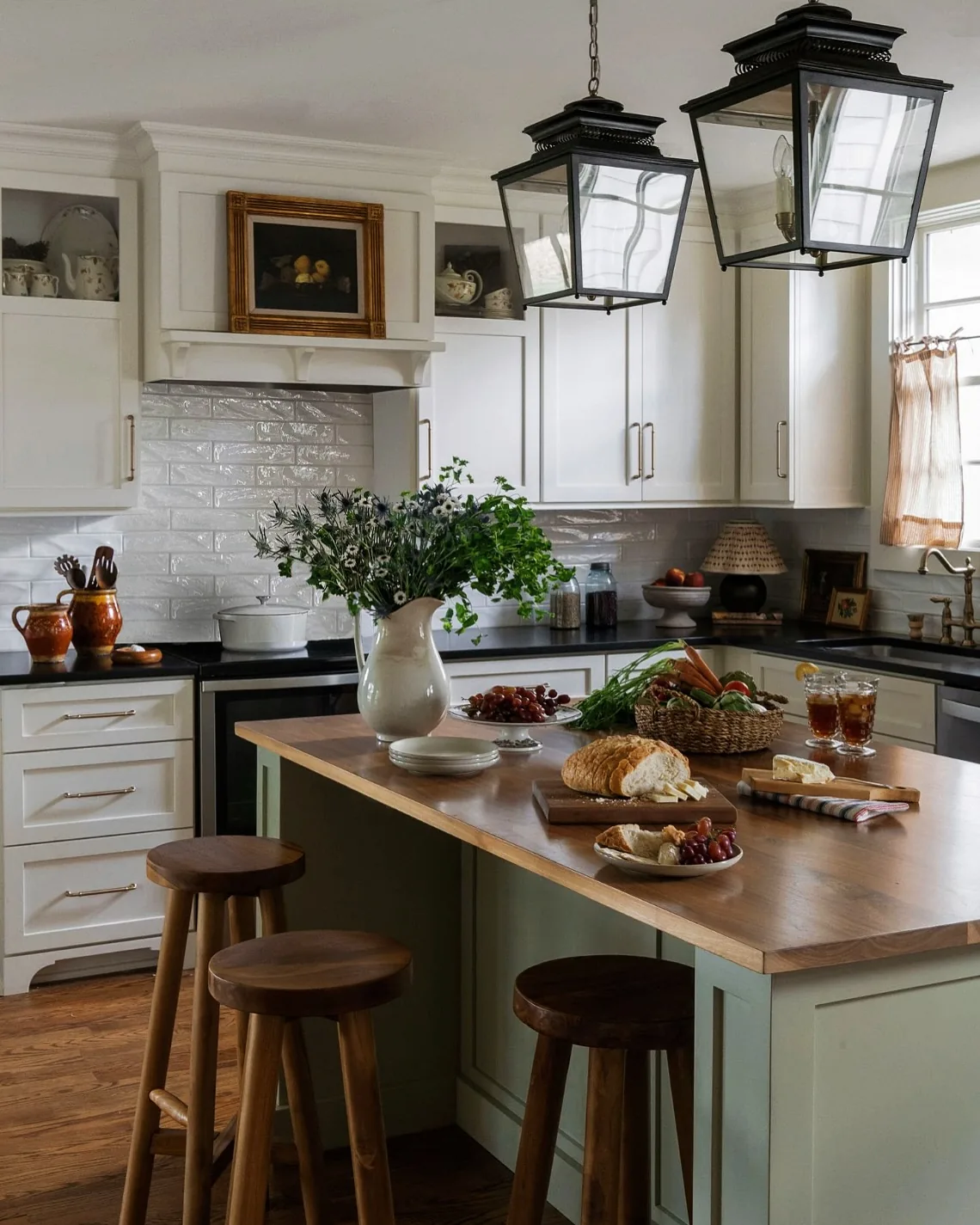 Farmhouse kitchen with a sage green island and a walnut countertop