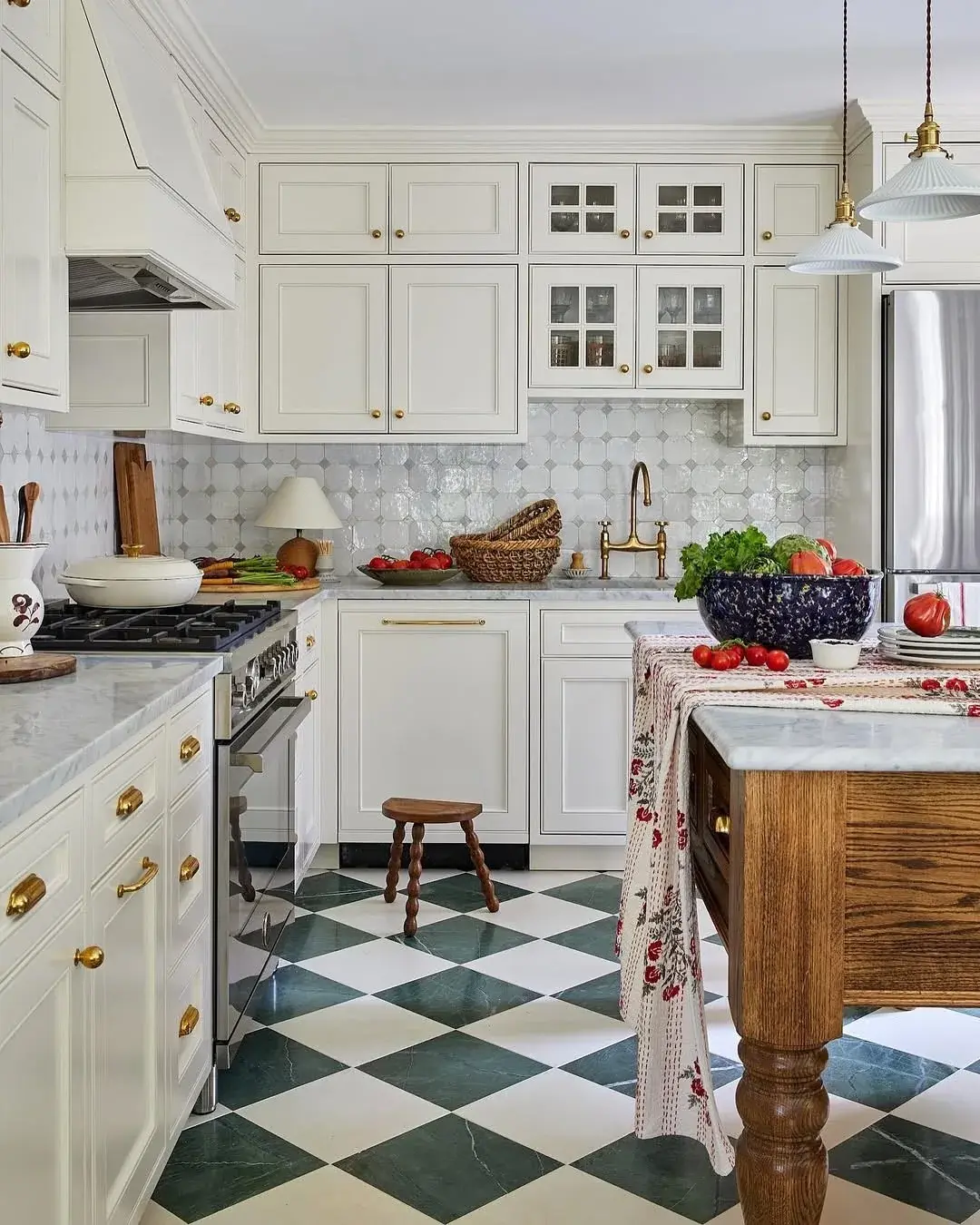 White kitchen with green and white chequered marble floor and white marble worktops