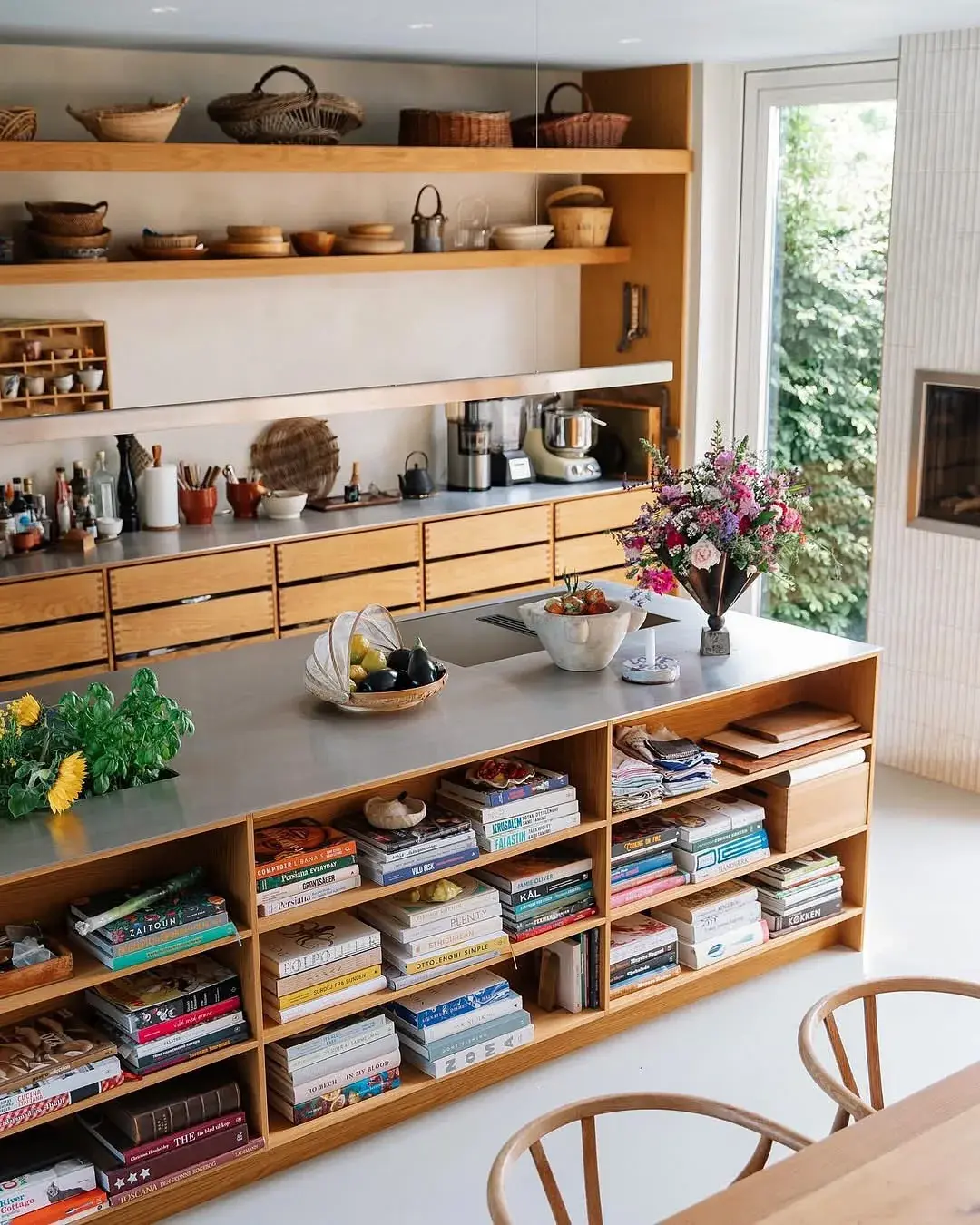 Oak island with open cookbook shelves and oak wall shelves with baskets