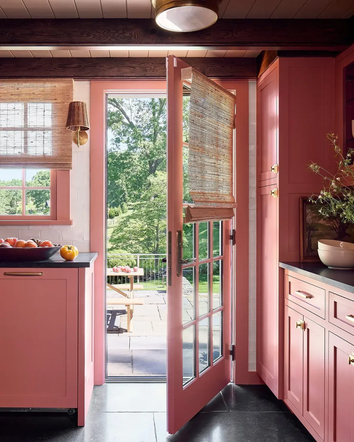 Coral kitchen where the cabinets, French door and window frame are all the same colour