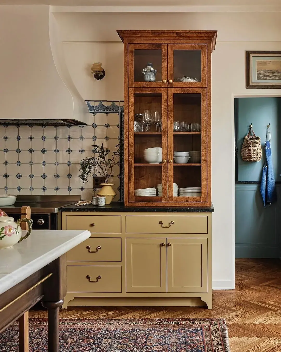 Antique figured walnut glazed cabinet standing on a pale painted base