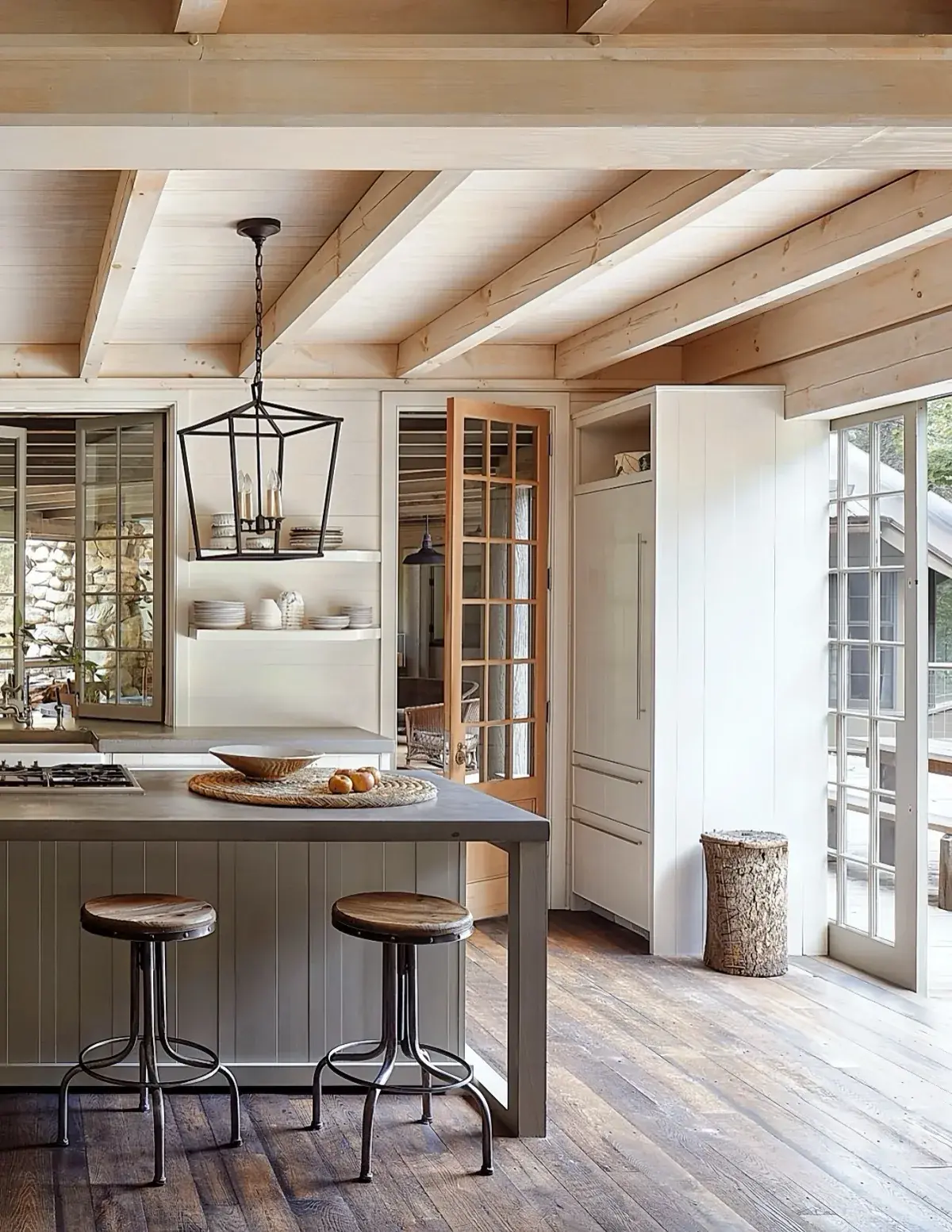Whitewashed beamed kitchen with grey island and dark plank floor