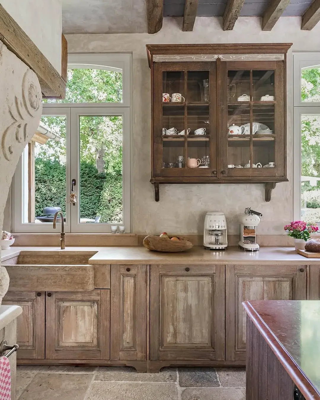 Weathered oak base units with dark glazed wall cabinet and stone sink