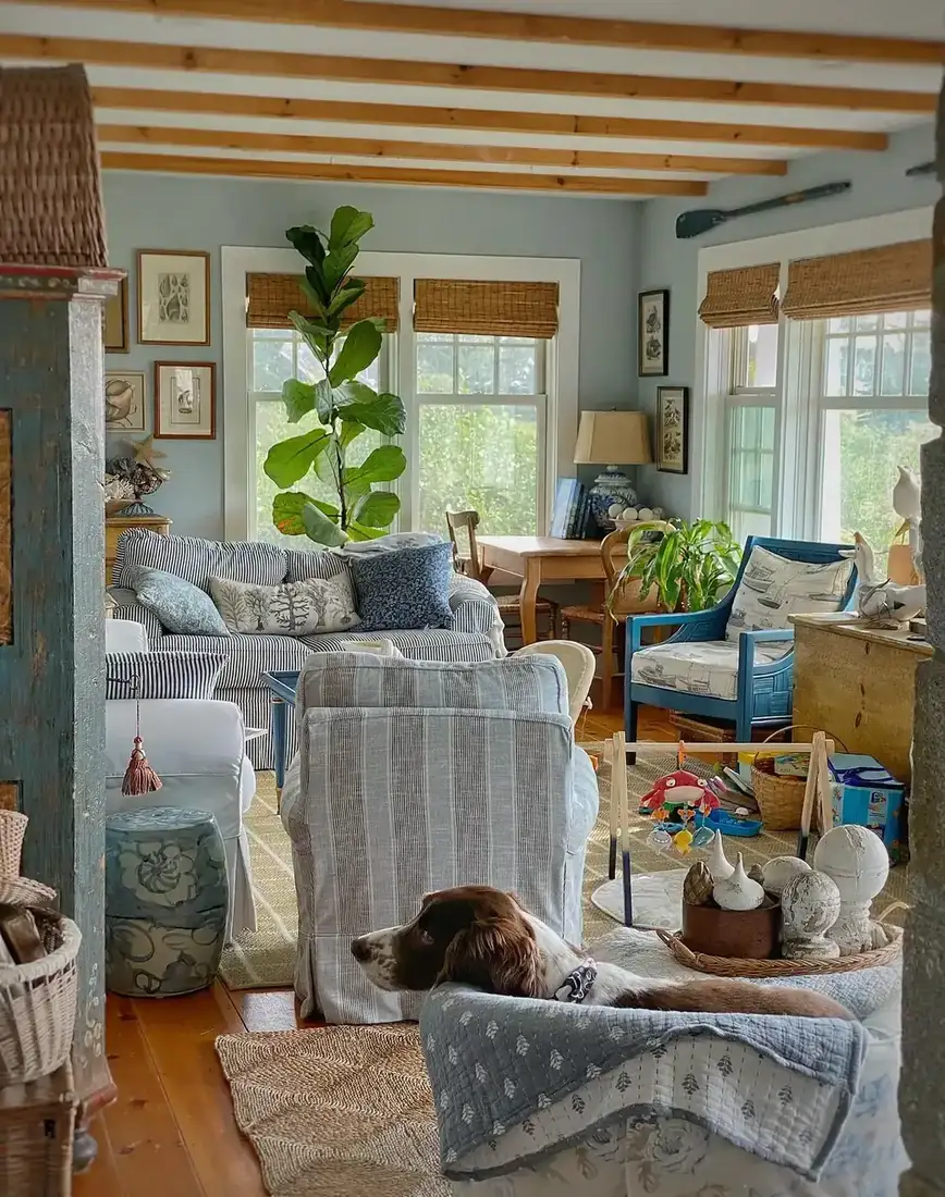 Blue and white cottage living room with woven grass shades at every window