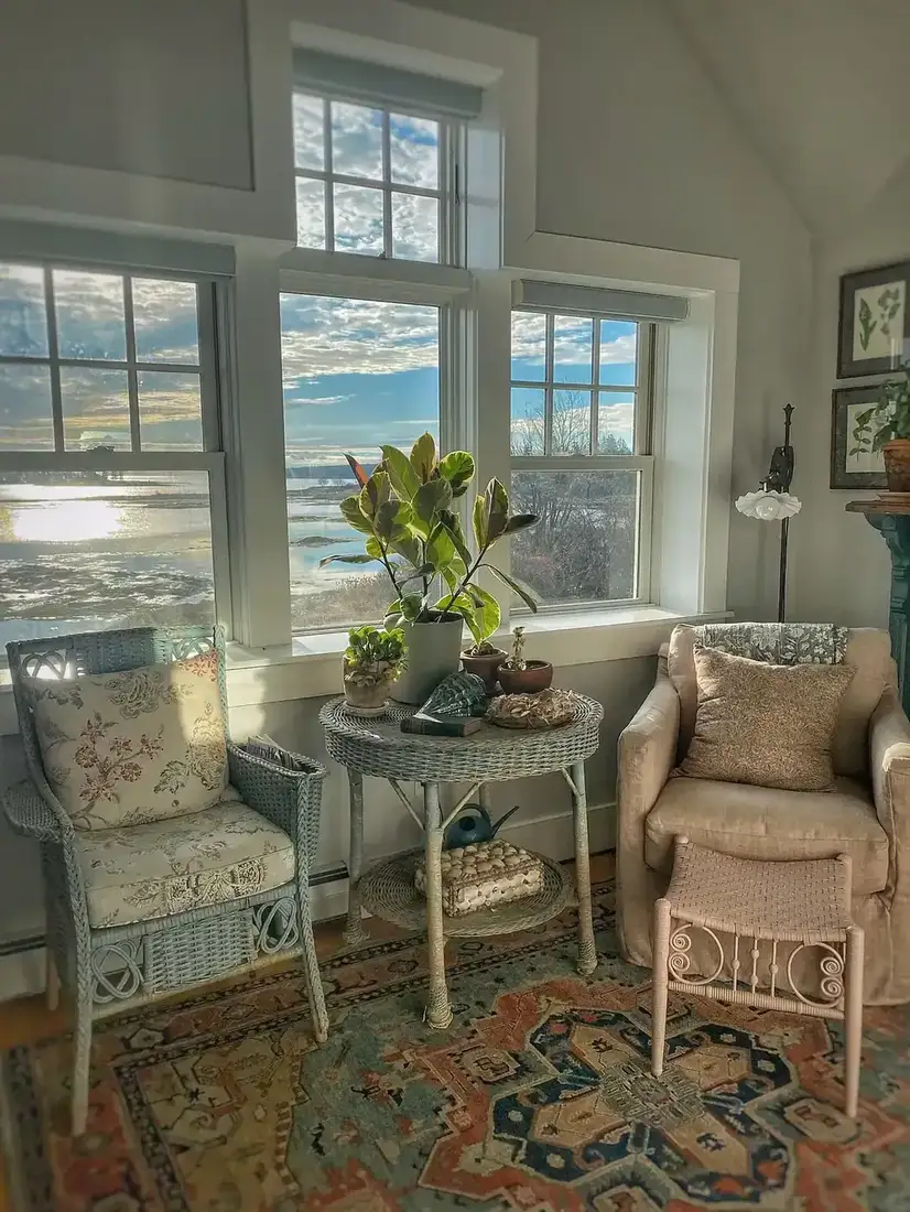 Sunlit corner with painted wicker chair, cane table and patterned rug