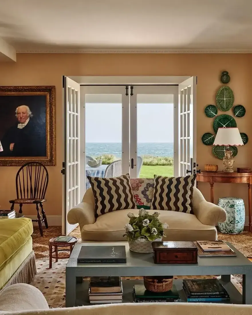 Elegant coastal living room with plaster walls, cream sofa and blue table
