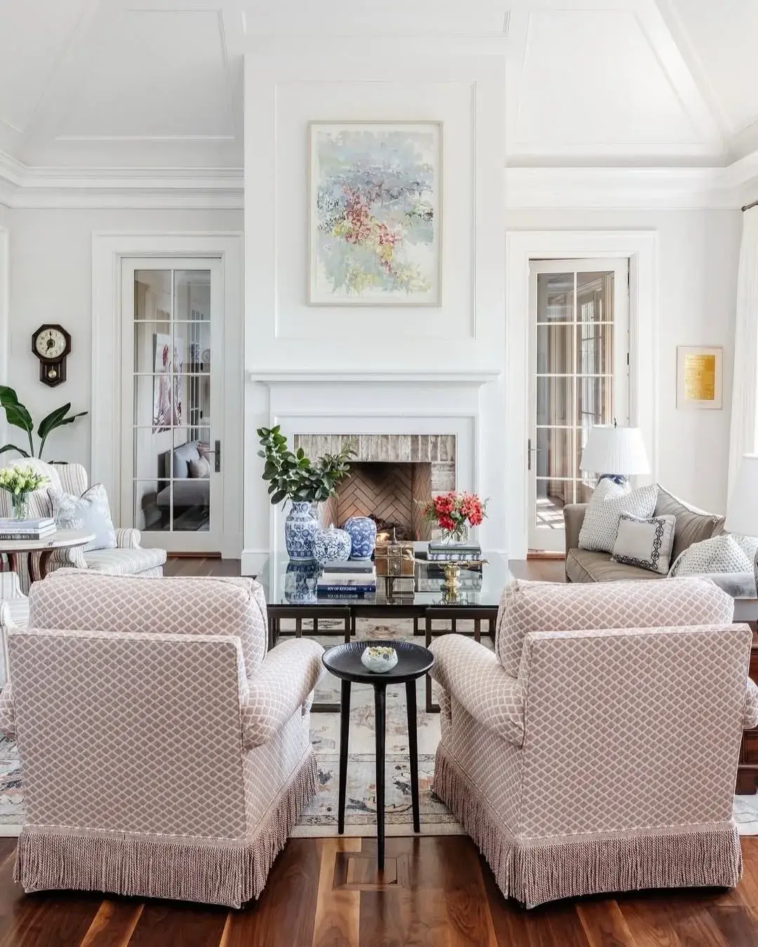 White living room with fringed chairs and blue ginger jars