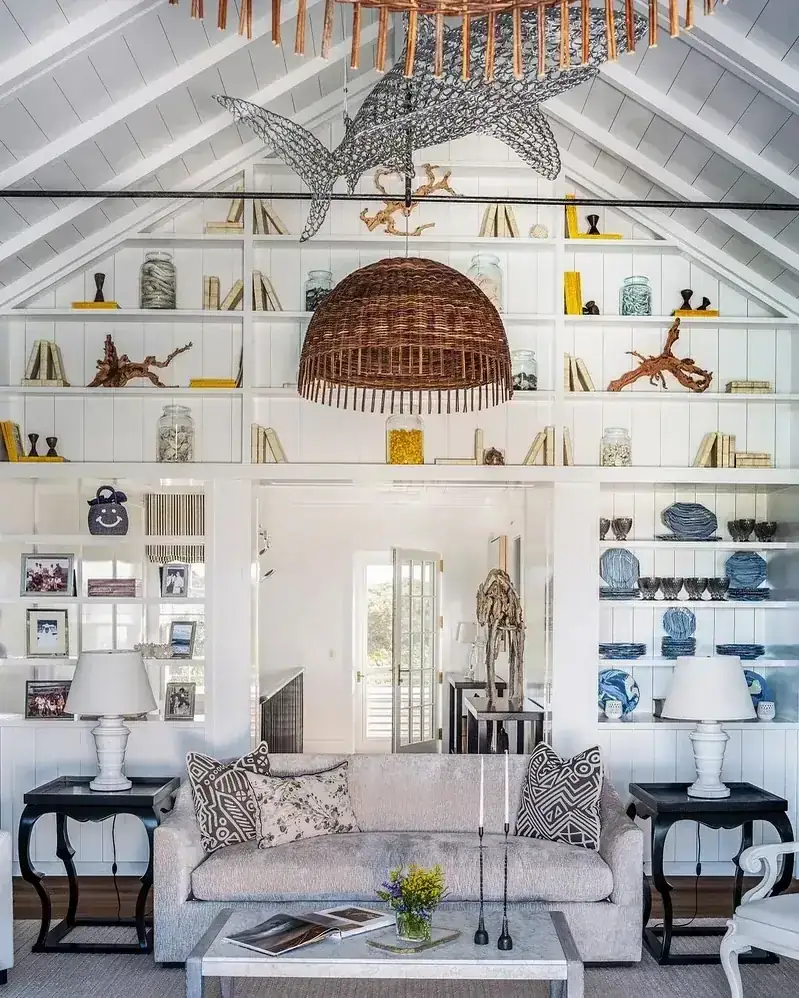 Vaulted white built-ins around a doorway with coastal objects and blue plates