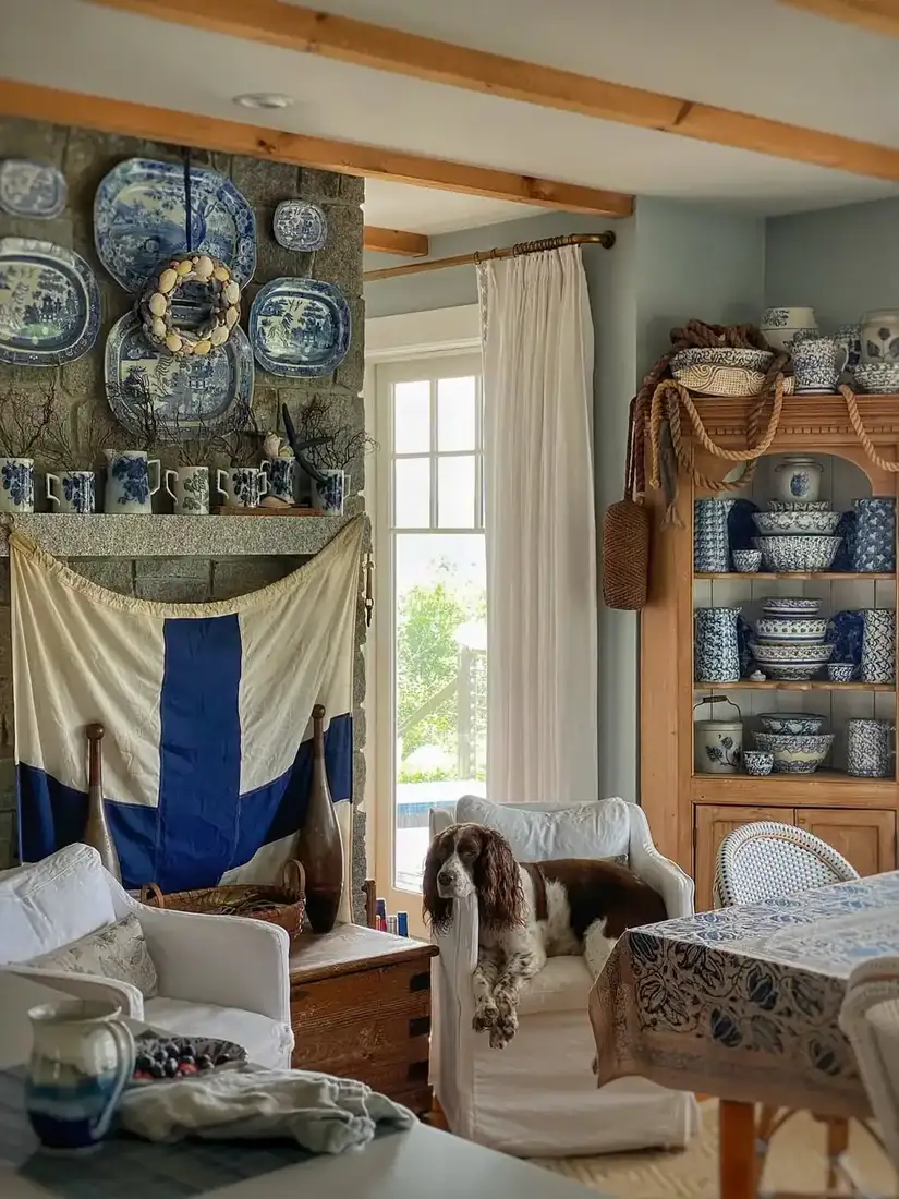 Stone fireplace with blue and white plates, signal flag and pine dresser of china