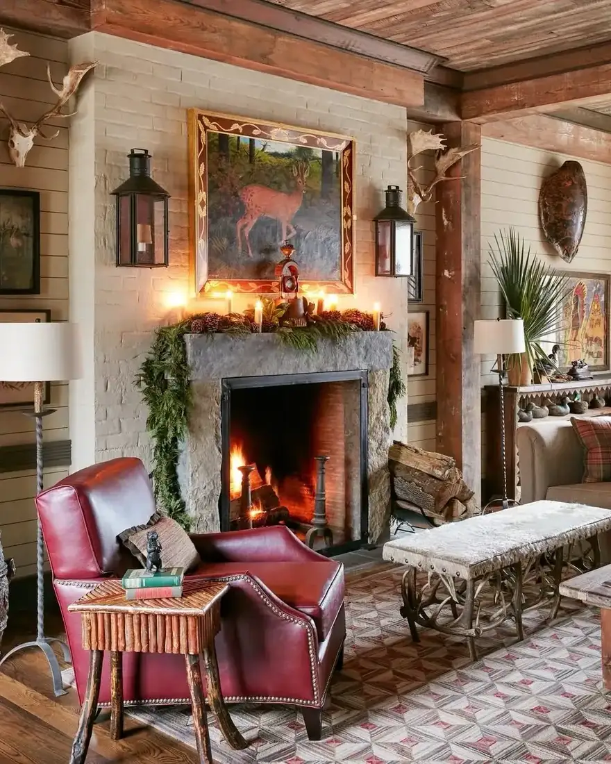 White brick fireplace with a stone mantel dressed with garland and candles beneath a large deer painting