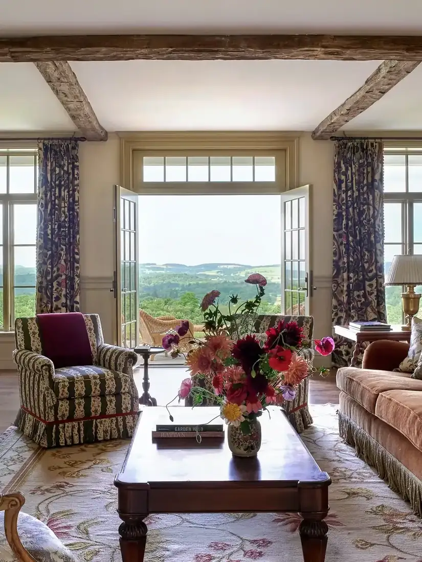 English country living room with layered floral chintz textiles in warm lamplight
