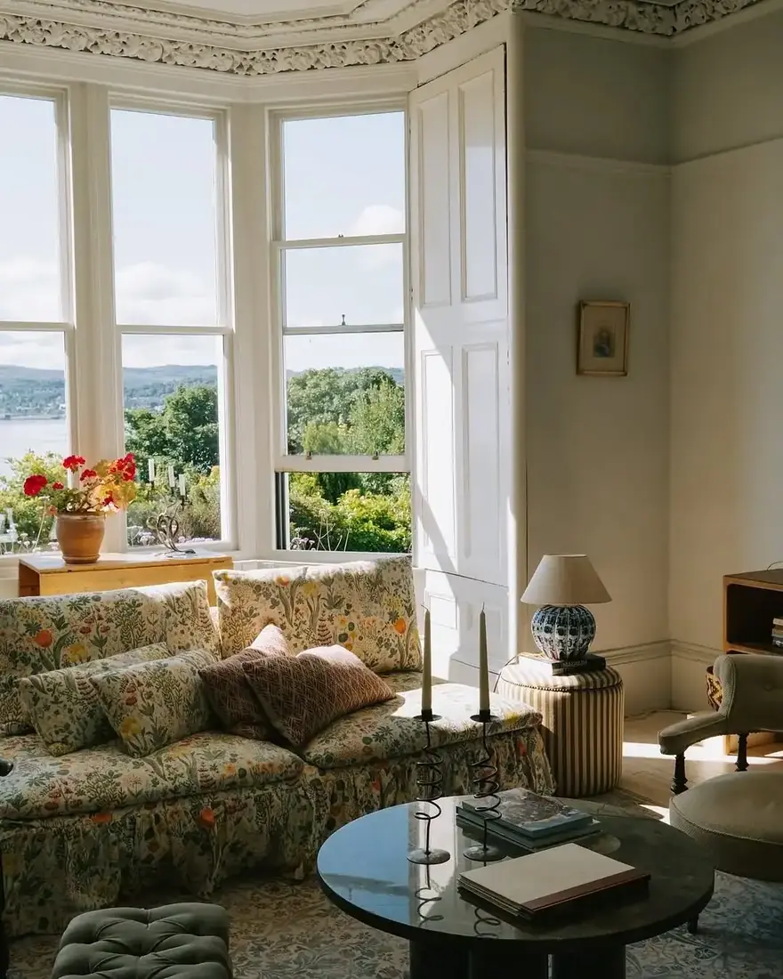 Floral sofa set in a bay window under natural daylight