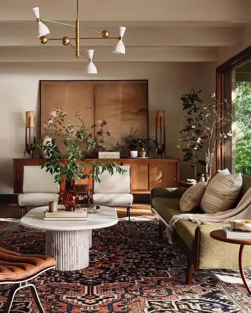Mid century room with teak sideboard, green sofa and patterned rug