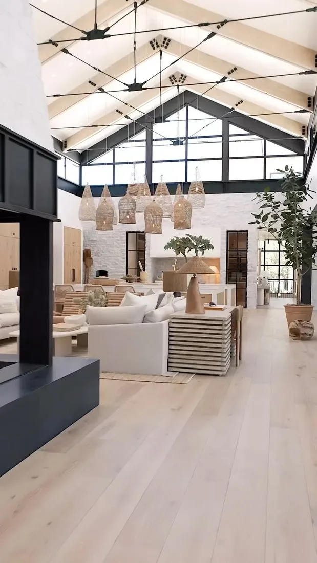 Vaulted barn room with rattan pendants, white sofas and pale oak floor