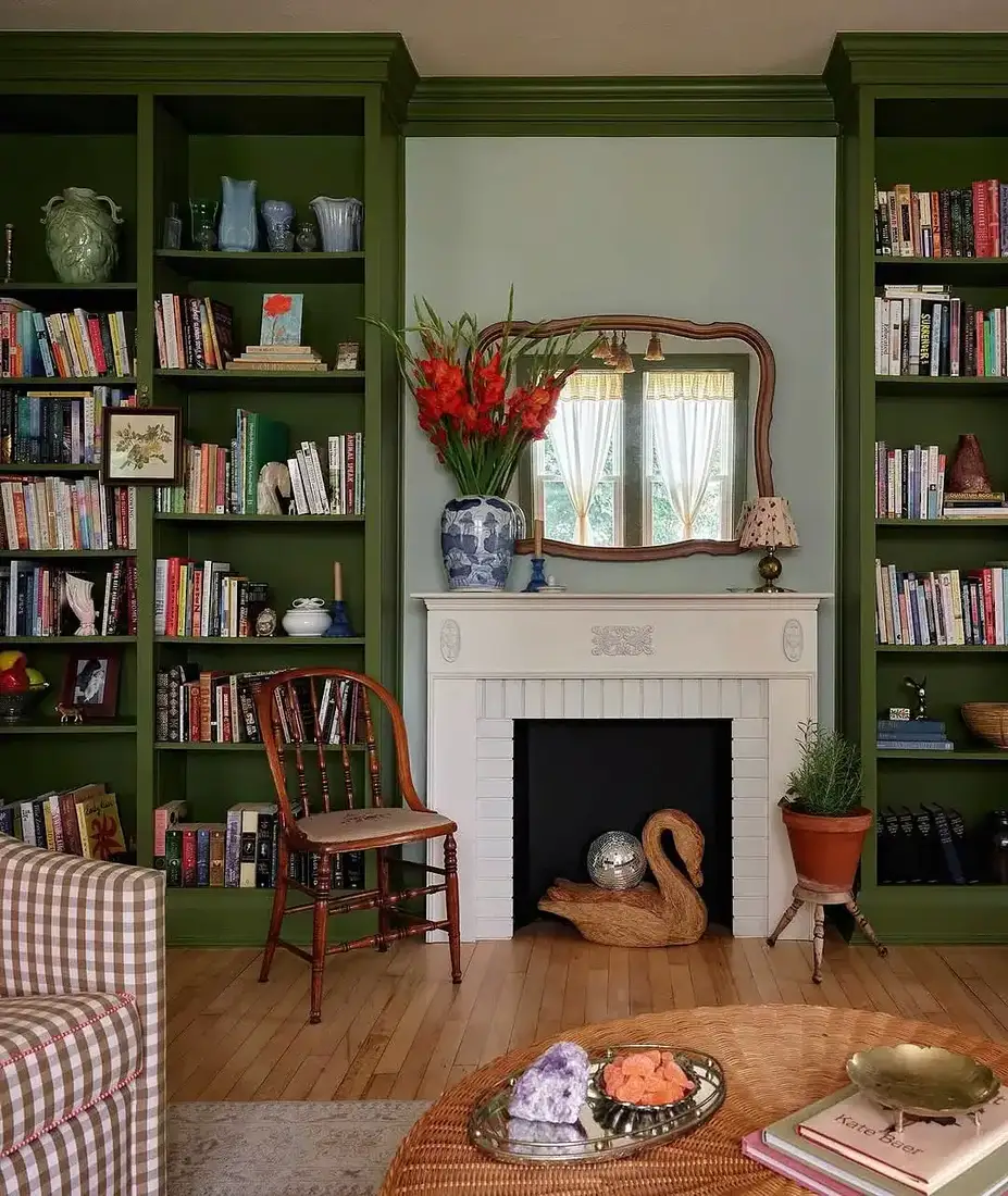 Cozy green bookshelf fireplace living room