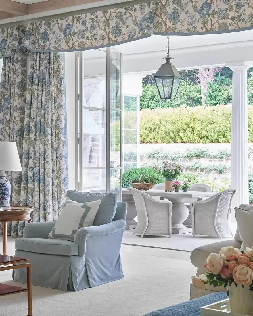 Floral curtains with matching pelmet beside open folding doors to a terrace