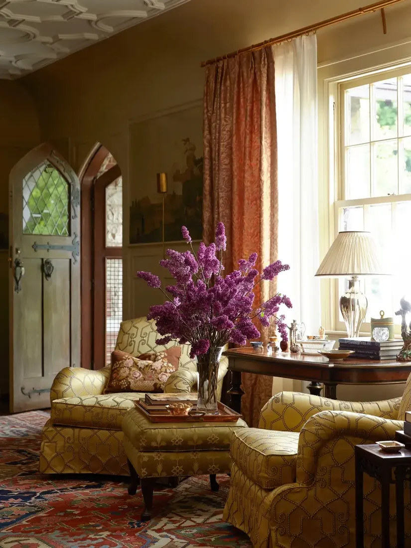 Olive sitting room with gothic doors, rust curtains, sheer, and lilacs