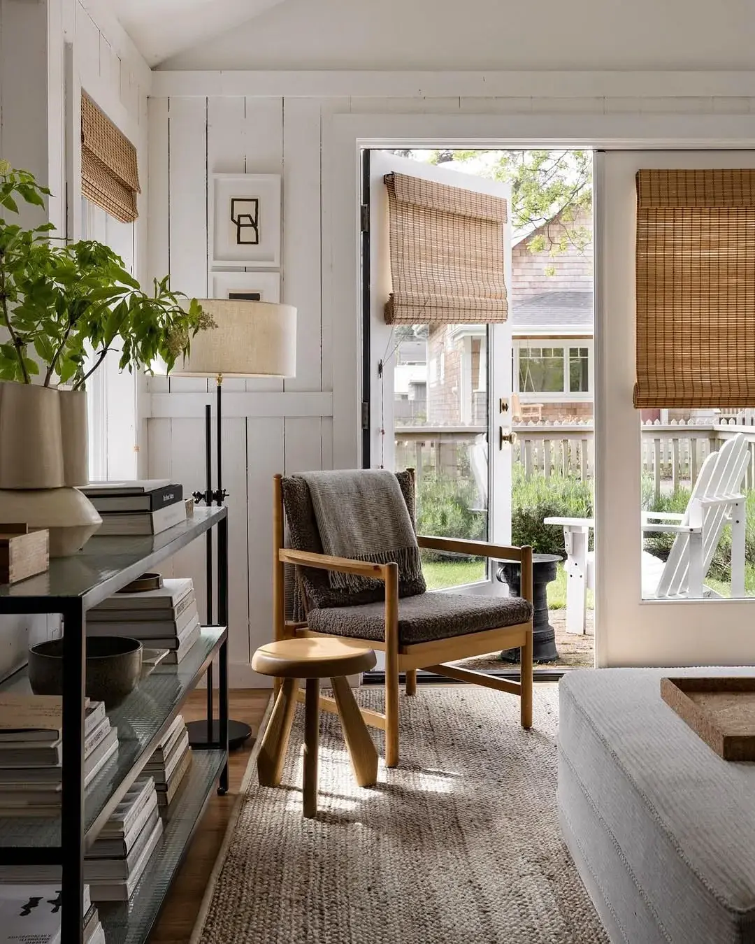 Natural woven roman blinds fitted inside each glazed door of a neutral panelled room