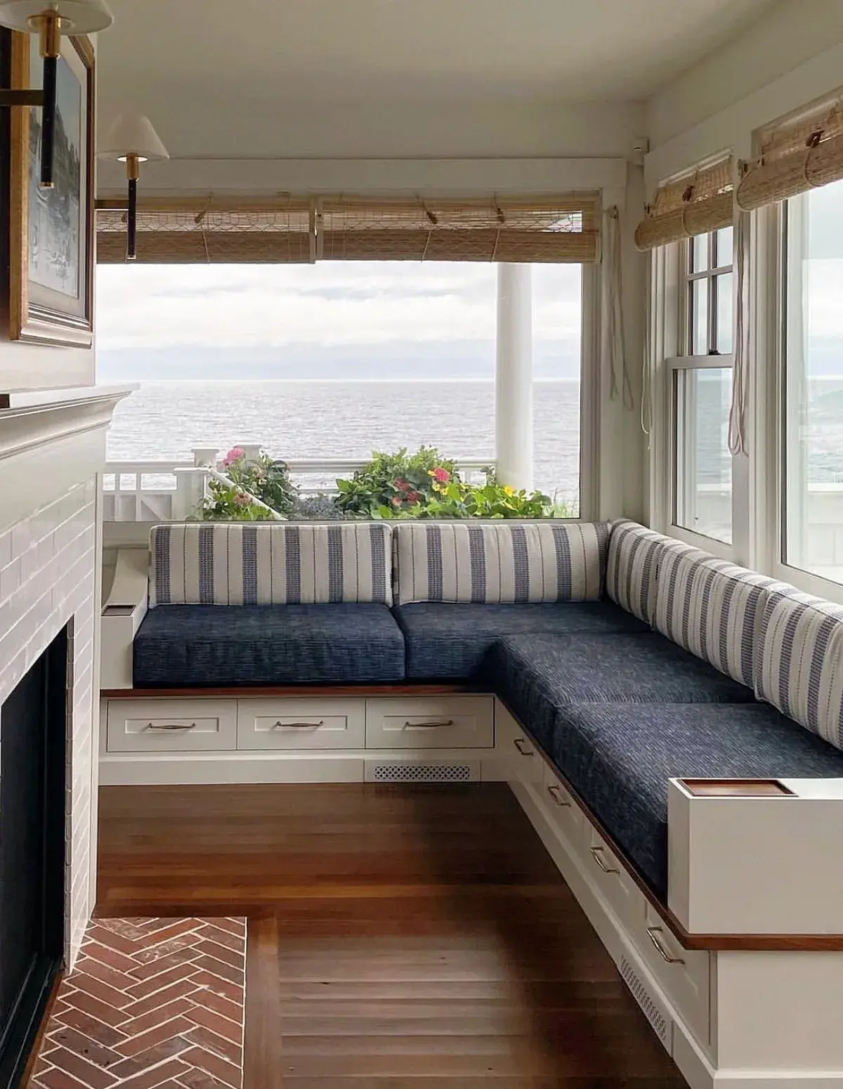 Navy L shaped banquette with striped backs facing sea