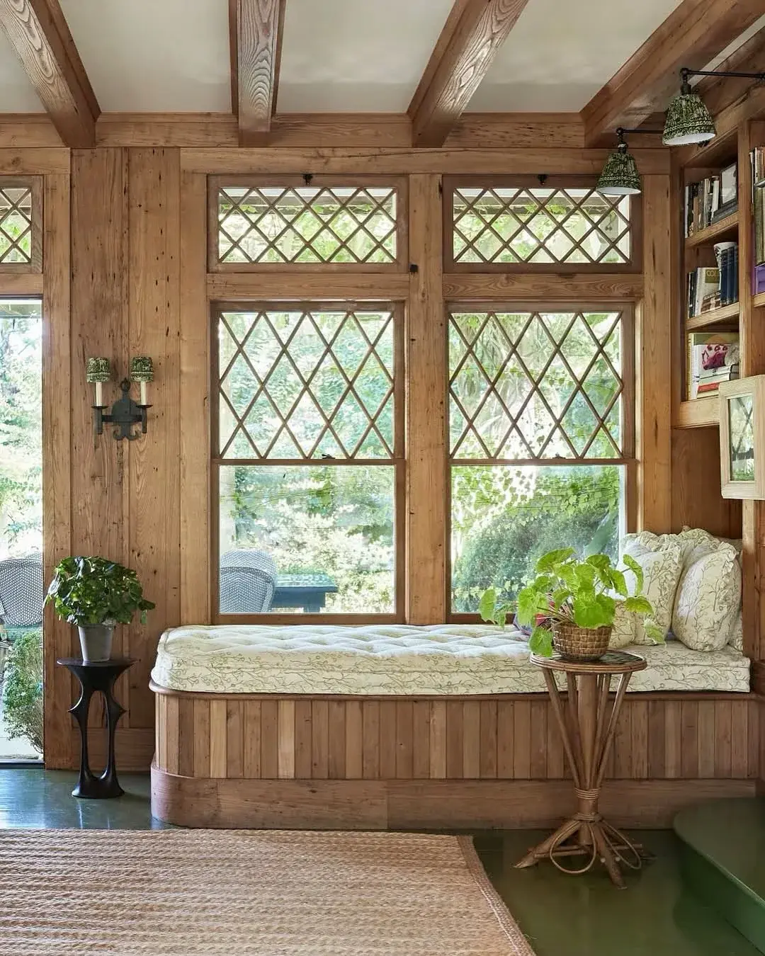 Long pine daybed under diamond windows in timber room