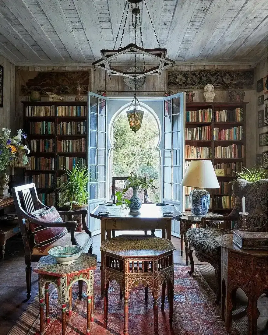 Collected library shelves with books, pictures and pottery at every height