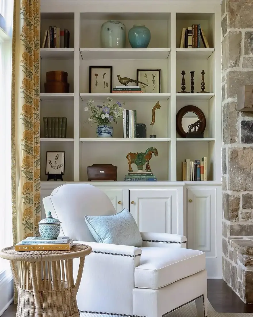 White shelves set against a rough stone wall with daylight raking across
